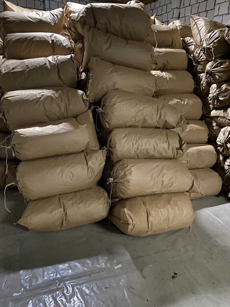 Rinsed and dried valerian root (Valeriana officinalis) packed in paper bags