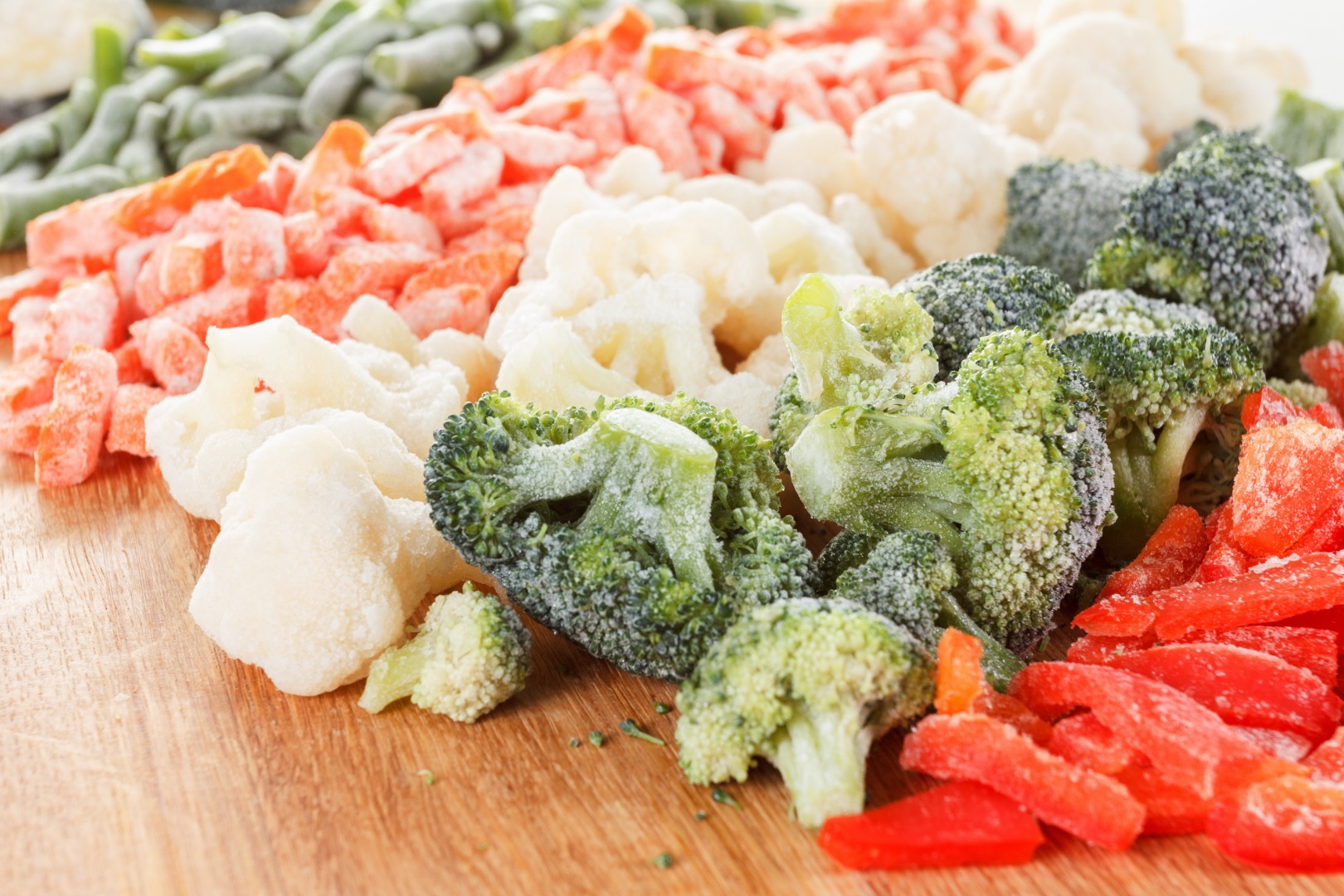 A selection of the best frozen fruits (strawberries, blueberries, cherries, sour cherries, figs, oranges, apricots, lemons) and vegetables (broccoli, peas